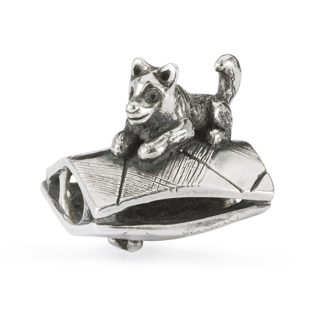 Silver jewellery bead with a dog hiding a bone under a carpet.